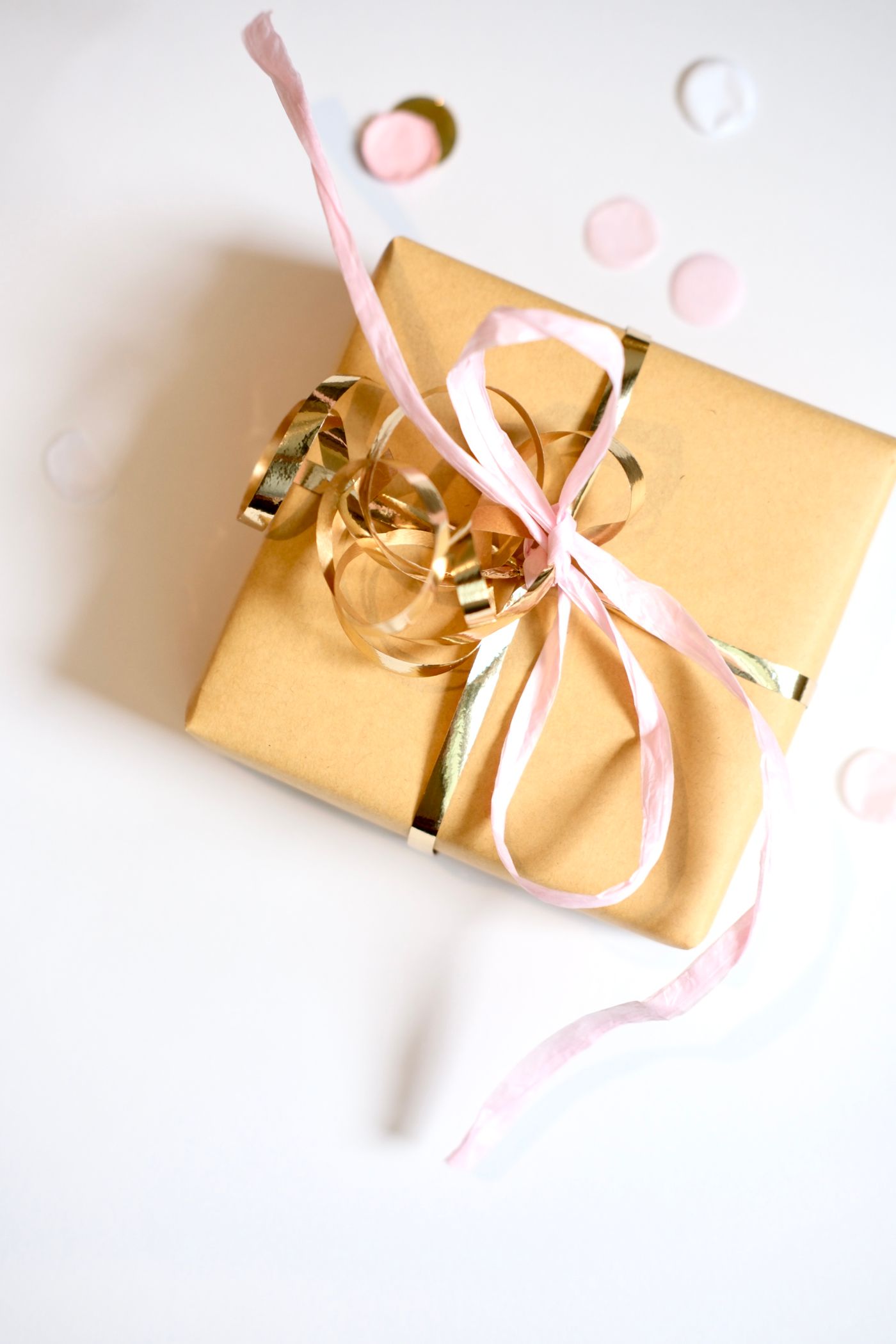 A wrapped gift box with a red ribbon and bow.