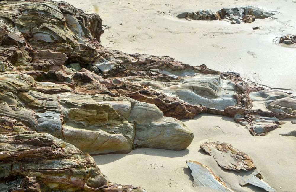 Coastal rocks along a shoreline, representing sustainable small choices.